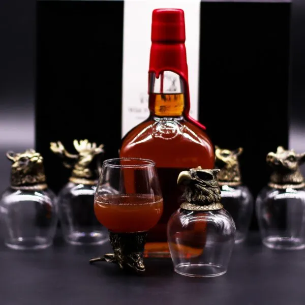 Whiskey Glass Set Metal Animal Base - Amber Collectors Edition Luxury whiskey set with animal‑sculpted metal base glasses and amber bottle on dark backdrop.