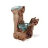 Molten glass and driftwood decorative sculpture blending blue-green glass with natural brown wood.
