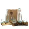Handcrafted Glass And Driftwood Set - Rustic Recycled Design Two handmade glass bottles and four small cups fused to natural driftwood bases before a HOME box.