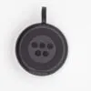 A black and white round Bluetooth shower speaker with control buttons and a hanging strap.