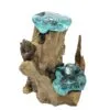 Hand-blown aqua glass bowls fused to rustic driftwood, forming an artistic natural decorative piece.