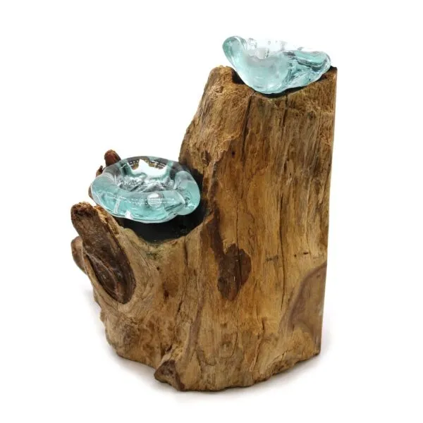 Hand-blown glass bowls fused into natural driftwood sculpture with organic textures and bluish-green hues.