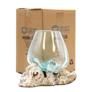 Hand-blown glass bowl fused to natural driftwood base with Ancient Wisdom packaging in background.