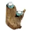 Rustic driftwood candle holder with two aqua glass tealight cups on natural textured wood.