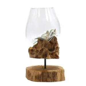 Hand-blown glass bowl resting on natural driftwood base with rustic wooden stand for home décor.