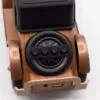 A retro-style wooden Bluetooth speaker with black controls and metallic bronze accents.
