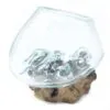 Handcrafted glass bowl fused to natural wooden base, rustic Balinese-style decorative home accent piece.