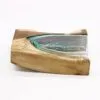 A sculptural art piece combining natural wood and green-tinted glass with organic, flowing contours.