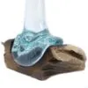 Molten Glass Sculpture Aqua Blue on Natural Wood Base Aqua-blue molten glass sculpture draped over natural wooden base, blending fluid glass with textured wood.
