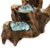 Molten glass sculpted onto natural driftwood base forming an organic aqua-blue decorative art piece.
