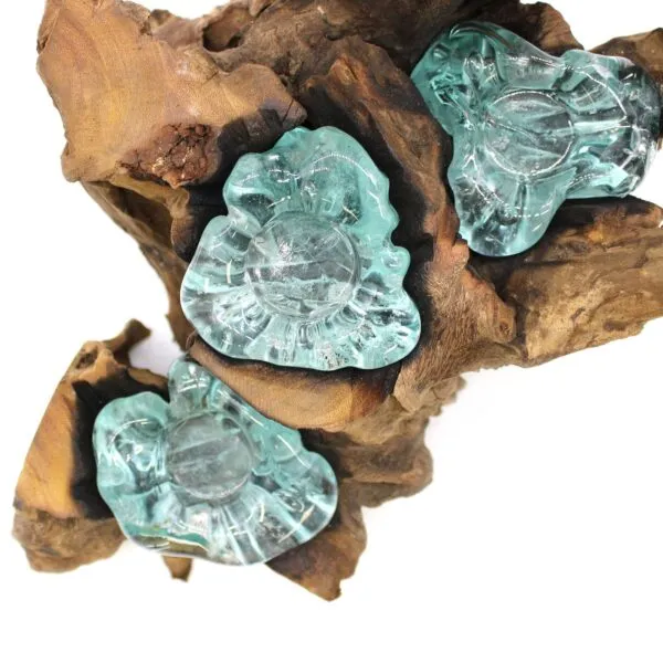 Organic wooden sculpture with translucent aquamarine glass forms resembling flowers, blending natural wood and glass artistry.