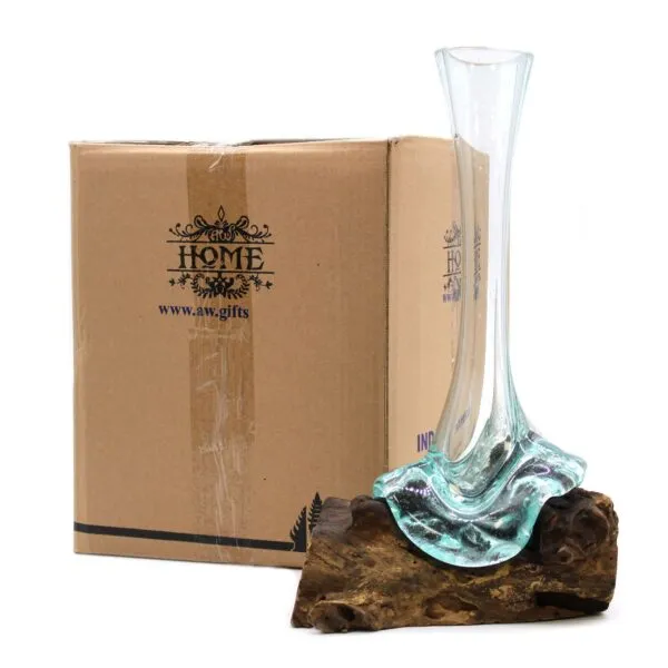 Hand-Blown Glass Vase Green Tint on Natural Wooden Base A hand-blown glass vase melted onto natural wood beside a brown HOME-branded cardboard box.