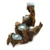 Driftwood candle holder with turquoise molten glass tealight cups and white candles.