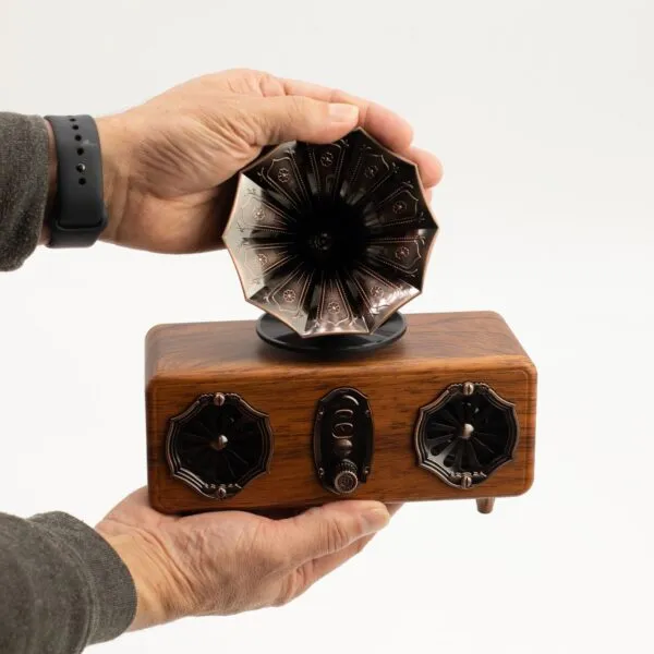 Vintage Wooden Bluetooth Speaker Black Horn - Retro Design A person holding a small vintage-style wooden Bluetooth speaker with a black gramophone horn design.