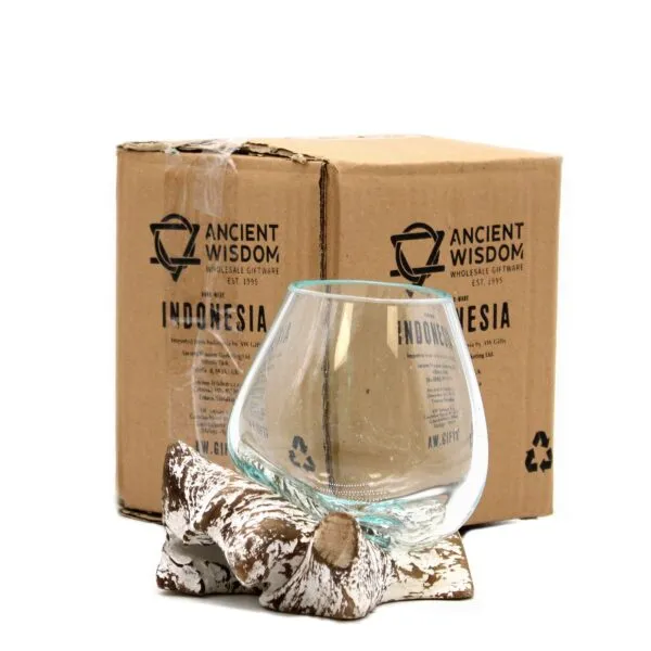 bG9jYWw6Ly9tZWRpYS8xTi80RS82MFIzMEMxRzZSVDM0RTFOLzNhNTgyYmI2LmpwZWc.webp Handmade recycled glass bowl on driftwood base in front of Ancient Wisdom cardboard boxes.