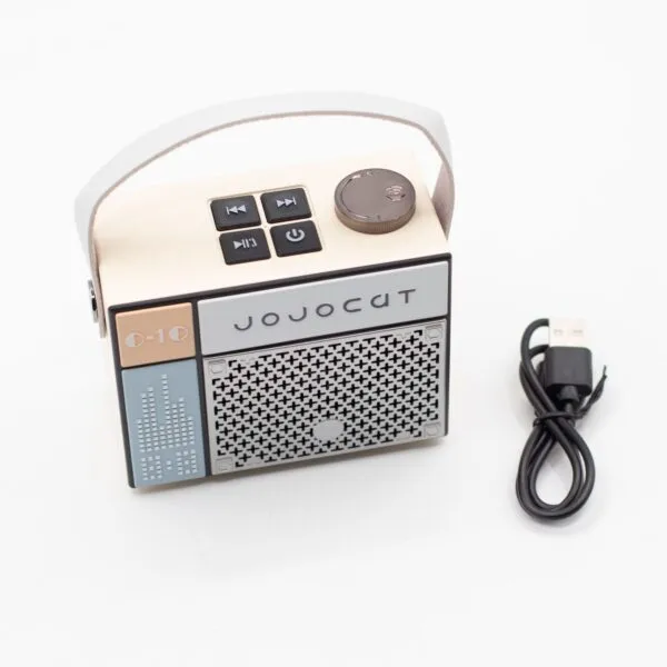 JoJoCat Retro Portable Speaker Beige - Bluetooth With Handle A beige retro-style portable Bluetooth speaker with handle and USB charging cable on a white background.