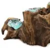 A decorative driftwood and turquoise glass sculpture blending natural wood textures with smooth molten glass.