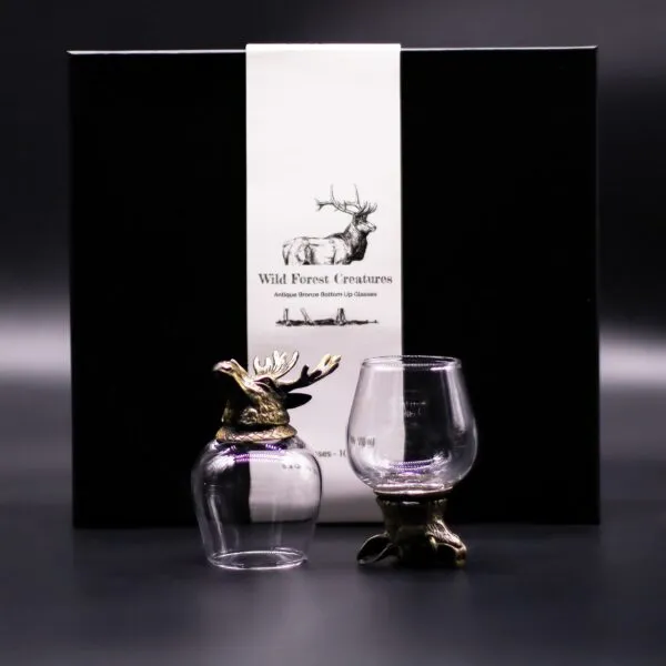 Wild Forest Creatures Bronze Glass Set - Black Gift Box Elegance Two bronze stag-themed bottom‑up glasses displayed with a black gift box featuring a white illustrated label.