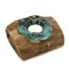A rustic driftwood and aquamarine glass candle holder with a white tealight candle.