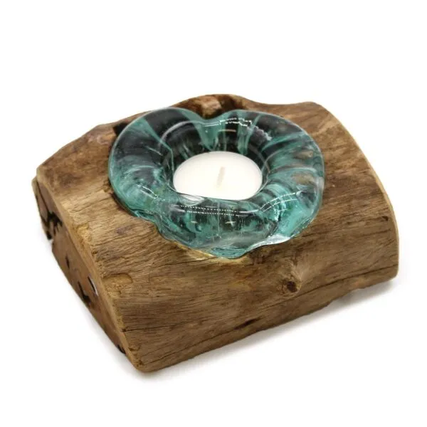 A rustic driftwood and aquamarine glass candle holder with a white tealight candle.