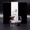 Wild Forest Creatures Glassware Set - Bronze Animal Design Two ornate glass drinkware pieces with bronze animal designs in front of a black luxury gift box.