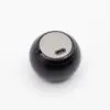 A small black spherical electronic device with a grey power button and USB-C charging port.