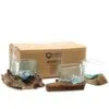 Hand-blown glass bowls on natural driftwood bases displayed before an Ancient Wisdom Indonesia box.