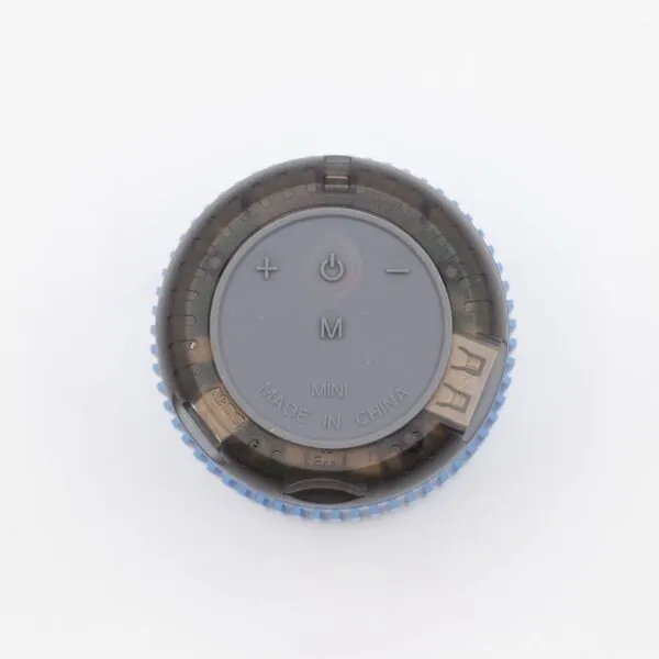 A small circular blue and black mini Bluetooth speaker with control buttons on a white background.
