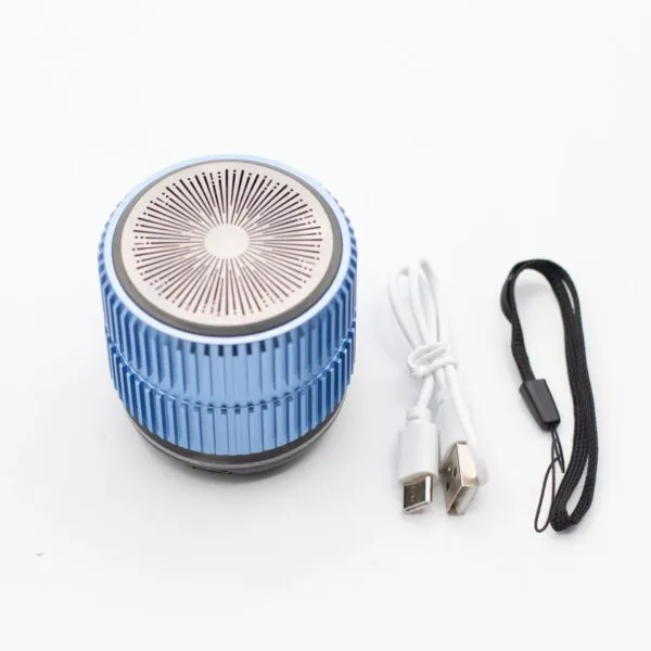 A metallic blue portable wireless speaker with USB charging cable and black wrist strap on white background.