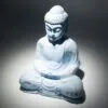 Buddha Statue Ceramic Light Blue - Meditative Dhyana Mudra Light blue Buddha statue in meditation pose under soft lighting, symbolising peace and enlightenment.