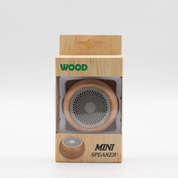 A small wooden mini speaker in woodgrain packaging with clear display window and green lettering.