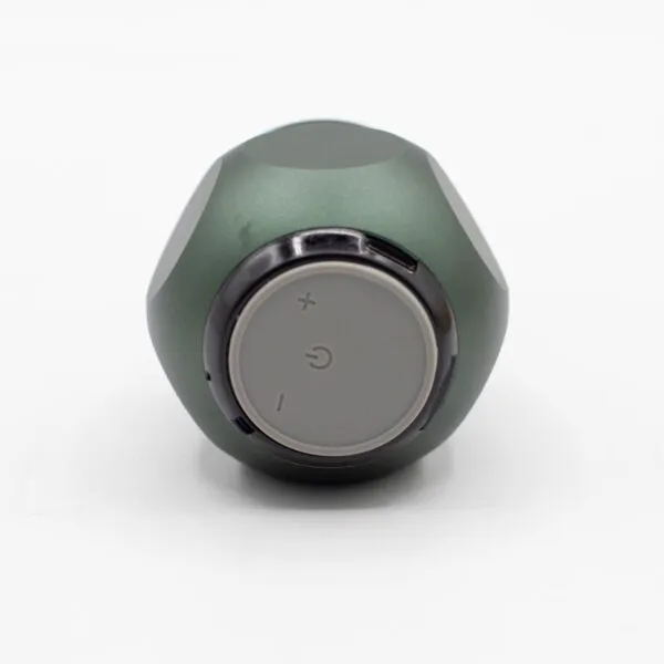 A compact matte green cylindrical electronic device with grey circular control buttons on a white background.