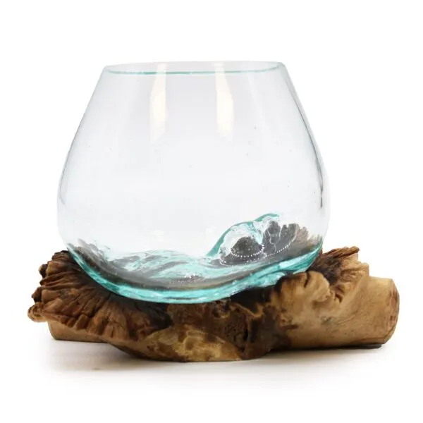 A handcrafted aqua-tinted glass bowl melted onto natural driftwood base for rustic home décor.