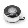 A compact silver and black circular Bluetooth speaker with a metallic grille and carrying loop.