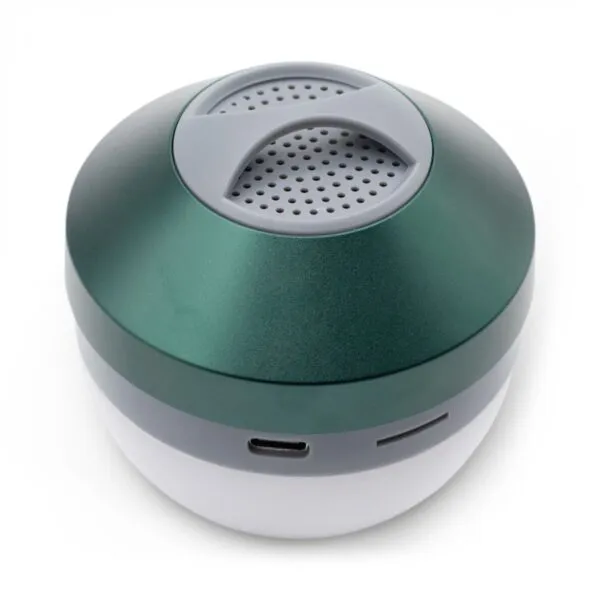 A small metallic green portable speaker with USB-C port and white translucent base on white background.