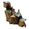 A handcrafted driftwood and aqua glass sculpture resembling cascading bowls in an organic, artistic design.