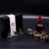 Luxury bronze mythical creature glassware set with whiskey bottle on dark elegant background.