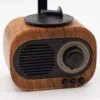Vintage wood‑grain Bluetooth speaker with volume dial, retro design, and modern wireless functionality.