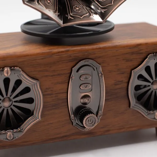Vintage Wooden Gramophone Speaker Bronze Finish Floral Grilles Vintage wooden Bluetooth gramophone speaker with bronze controls and ornate floral metal grilles.