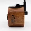 Close-up of a sleek wooden electronic device with USB-C, USB-A, and audio ports.