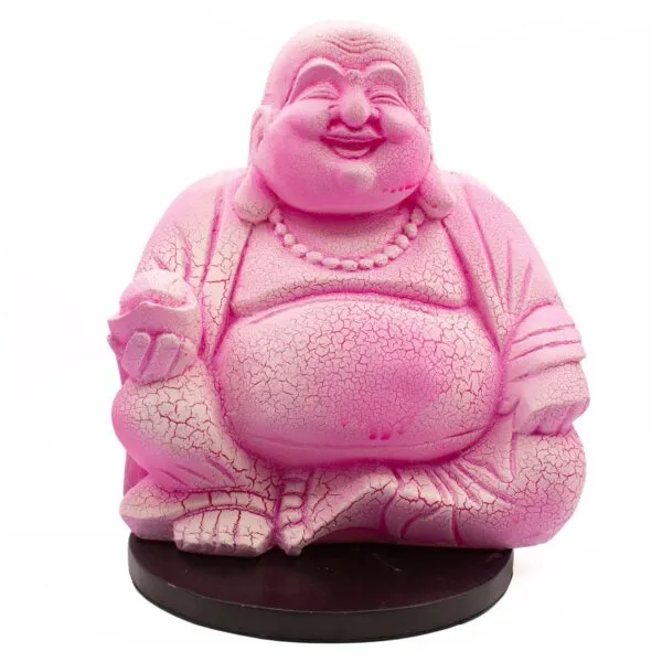 Bright pink Laughing Buddha statue with cracked texture sitting cross-legged on a dark brown base.