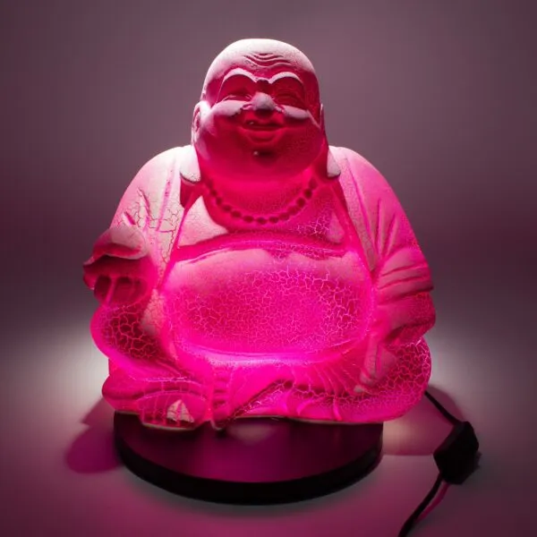 Boho Chic - Ambient Lighting gifts - Illuminated pink Laughing Buddha statue lamp with glowing belly on a dark circular base.