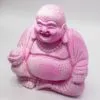 Laughing Buddha Lamp Dragonfruit. seated cross-legged with joyful smile against light background