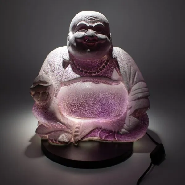 A glowing lilac Laughing Buddha lamp with a cracked glass texture on a black base.