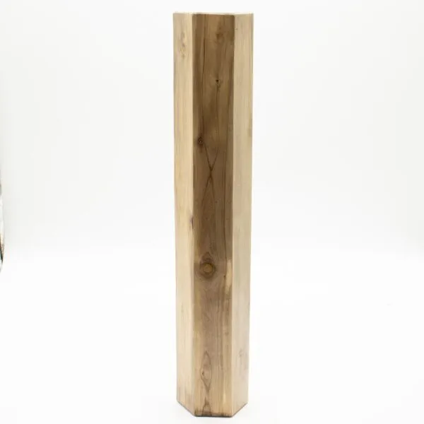 A hexagonal natural wood block with visible grain and knots on a white background.