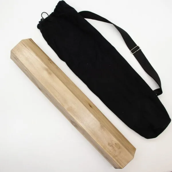 A light-brown wooden box and a black canvas bag on a white surface.