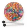 Colourful floral steel tongue drum with two mallets on a light grey surface.