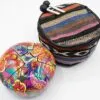 A colourful steel tongue drum with a patterned carrying case and two mallets.