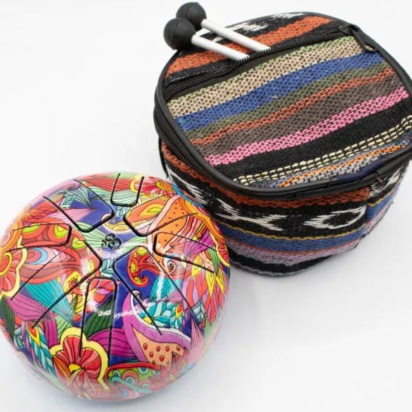A colourful steel tongue drum with a patterned carrying case and two mallets.
