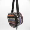 A colourful handmade Nepalese woven fabric messenger bag with circular panels and black strap.